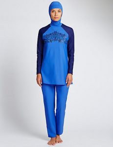 [A model posing in a blue burqini made by Marks & Spencer.]