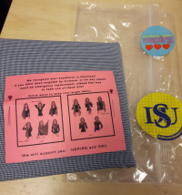 [A photo of an “emergency hijab kit”, showing a folded piece of fabric and instructions for how to wear it, next to the plastic bag it comes in with Nova Scotia Public Interest Research Group and Dalhousie Student Union stickers.]